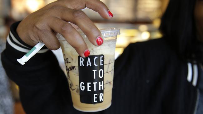FILE - In this March 18, 2015 file photo, Larenda Myres holds an iced coffee drink with a 
