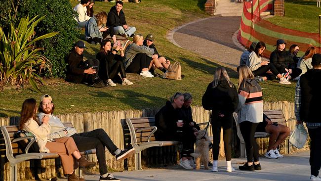 People sit along the grassy area at Bondi Beach in Sydney on Tuesday. Picture: AFP