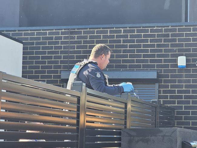 Police dust for prints on the fence they believed was used to access the property. Picture: Jordan McCarthy