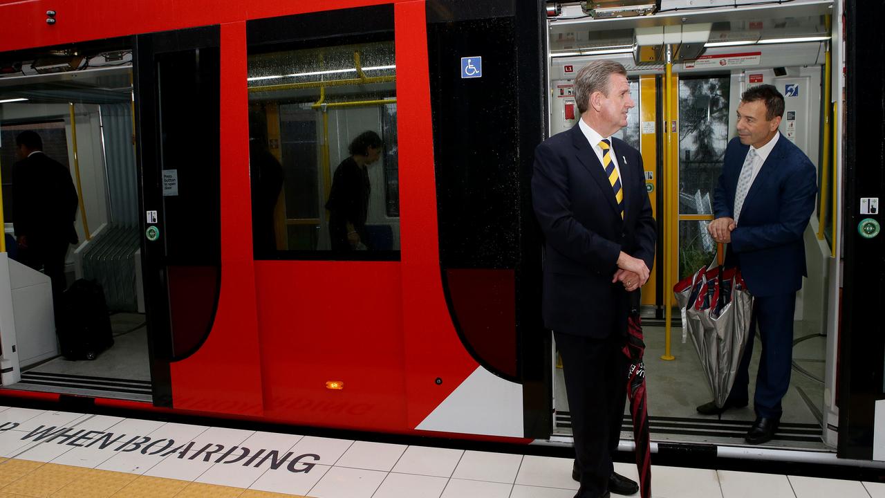 Then-premier Barry O’Farrell and Strathfield MP Charles Casuscelli ride the first tram on the line in 2014.