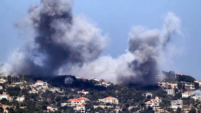 A cloud of smoke erupts during an Israeli air strike on the village of Sujud in southern Lebanon on September 25, 2024. Israel announced dozens of new air strikes on Hezbollah strongholds in Lebanon on September 24, a day after 492 people, including 35 children, were killed in the deadliest bombardment since a devastating war in 2006. (Photo by Rabih DAHER / AFP)