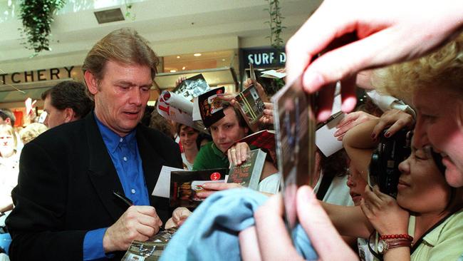 Fellow Aussie music icon John Farnham signed scores of autographs for camera-wielding fans on October 19, 1996, when he even scribbled his name on the arms of some diehards.