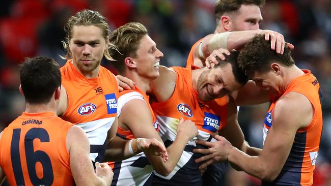 Teammates mob Sam Reid after he kicked a goal against Collingwood. Pic: Getty Images