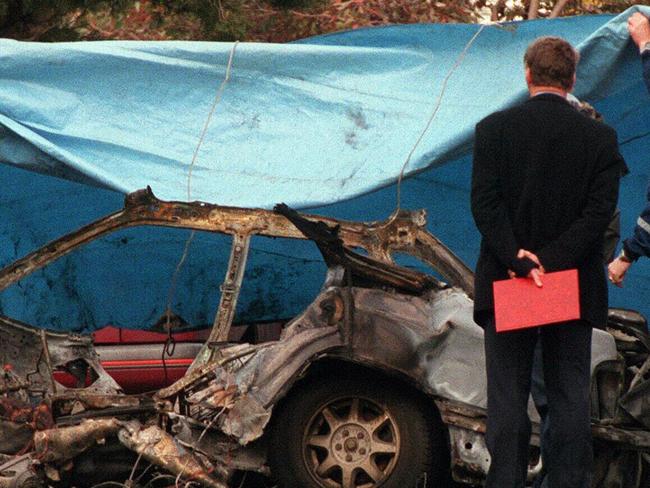 Police examine remains of Subaru Liberty destroyed by massive blast, believed to be caused by bomb, killing driver John Furlan (48) in North Coburg, 03/08/98.Victoria / Bombing / Motor Vehicle / Car