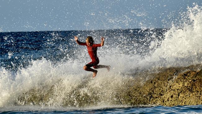 Young swimmers knocked down by swell at Snapper Rocks on the Gold Coast generated by Tropical Cyclone Oma. Picture: Mark Furler.