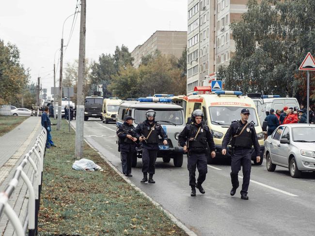 Policemen walk near the scene of a shooting in school No88 in Izhevsk. Picture: Kommersant Photo / AFP