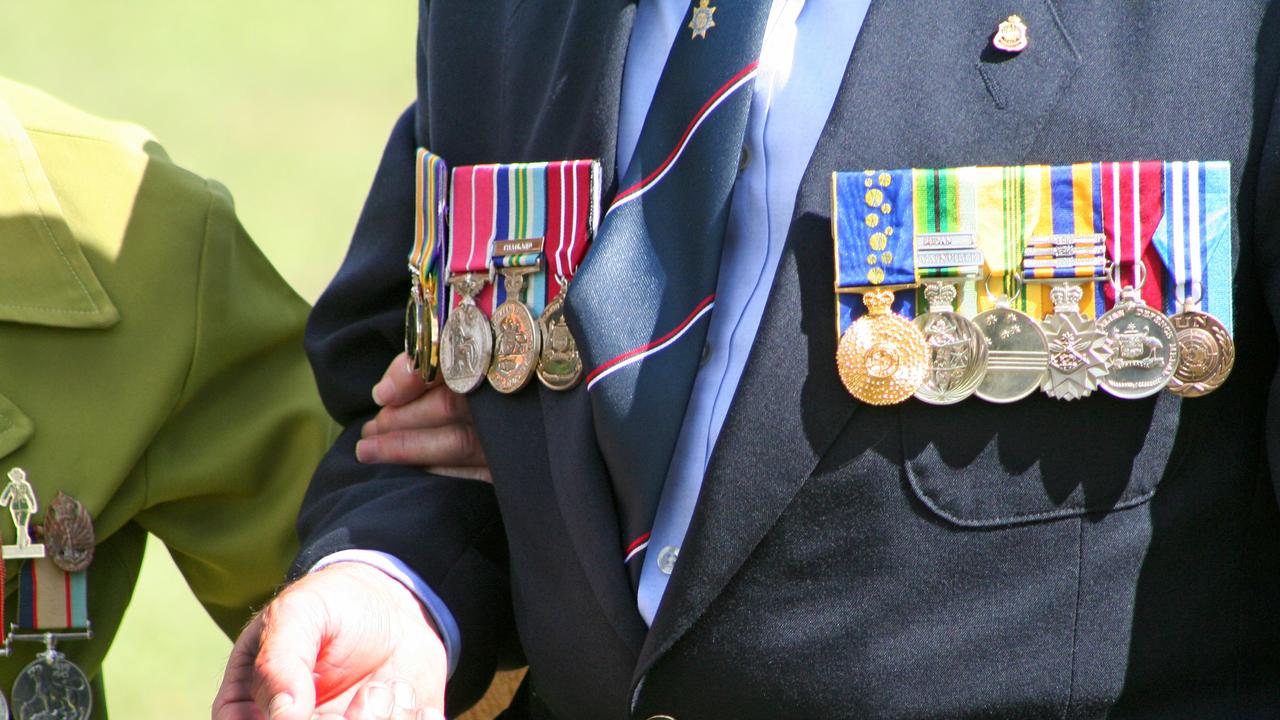 An elderly widow wearing war medals. Picture: File