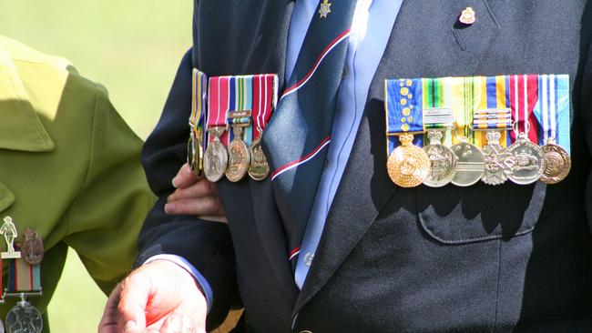 An elderly widow wearing war medals. Picture: File