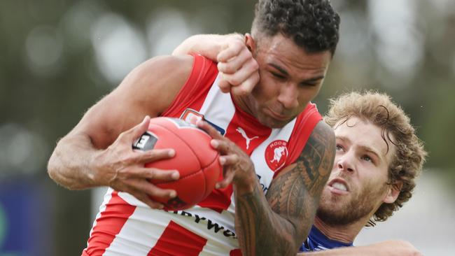 Rooster Frank Szekely is collared by Bulldogs opponent Marcus Barreau at Elizabeth. Picture: SANFL Image/David Mariuz.