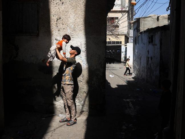 A Palestinian man plays with a child in Rafah, on the southern Gaza Strip. Picture: AFP