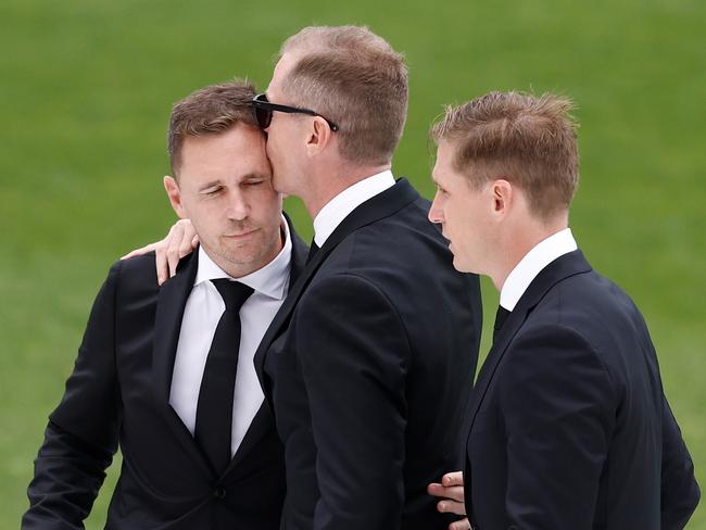 GEELONG, AUSTRALIA - FEBRUARY 14: (L-R) Joel Selwood, Adam Selwood and Scott Selwood embrace during Troy Selwood's Funeral Service at GMHBA Stadium on February 14, 2025 in Geelong, Australia. (Photo by Michael Willson/AFL Photos via Getty Images)