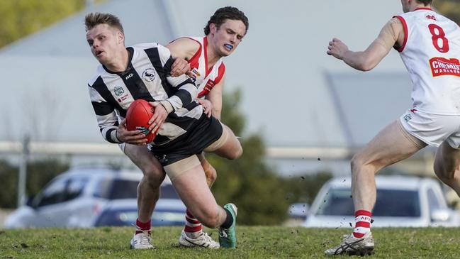 OEFL: Narre Warren’s Tom Miller beats Tyler Belloni of Olinda-Ferny Creek to the footy. Picture: Valeriu Campan