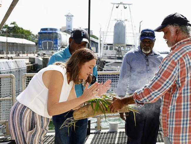 Greenpeace ship the Rainbow Warrior has docked in Cairns, where it is due to set sail on its Pacific Climate Justice tour on June 26. Pacific Climate Justice Tour project leader Steph Hodgins-May, Pabai Pabai from Boigu Island and Paul Kabai from Sabai Island receive a traditional Welcome to Country smoking ceremony from Gimuy Walubara Yidinji elder Hendrick Fourmile on the ship's deck ahead of the commencement of the Pacific Climate Justice tour. Picture: Brendan Radke