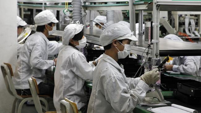 Workers operate on the assembly line in China.