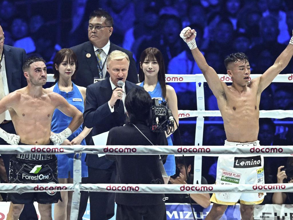 Japan's Yoshiki Takei (R) celebrates his upset decision victory over Australia's Jason Moloney (front L) at the end of their WBO bantamwight title boxing match at the Tokyo Dome in Tokyo on May 6, 2024. (Photo by Philip FONG / AFP)