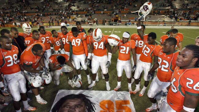 Rashaun Jones with teammates over a mural of Bryan Pata. Photo: Doug Benc, Getty.