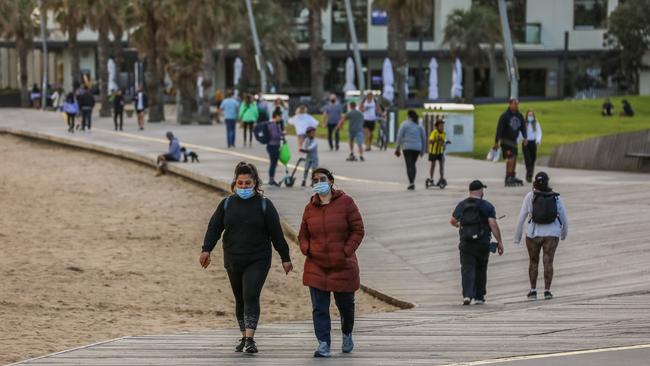 People walking along St Kilda beach on Saturday. Picture: Asanka Ratnayake