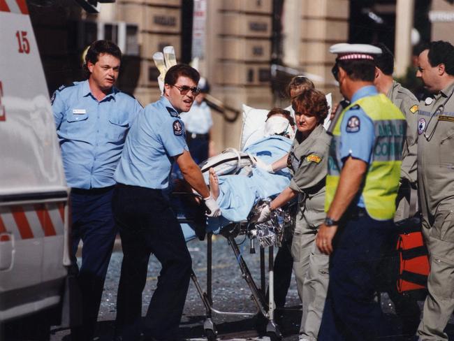 NCA lawyer Peter Wallis is put into an ambulance.