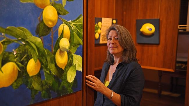 Artist Alison Mithcell with her paintings of citrus fruit at the Museum of Economic Botany, Adelaide Botanic Garden. Picture: Tom Huntley