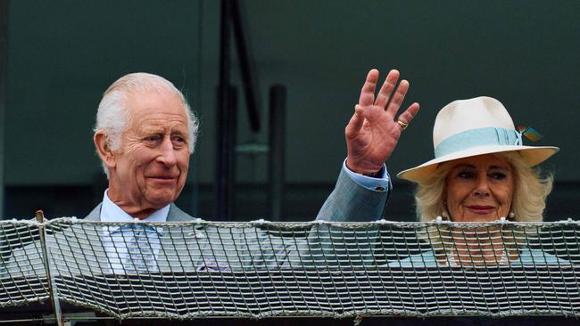 King Charles III and Queen Camilla wave to the crowd on the first day of the Epsom Derby Festival horse racing event in Surrey, southern England in May. Photo AFP