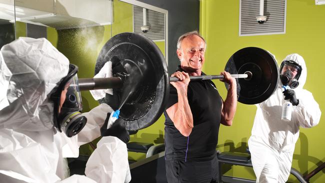 Manager of Anytime Fitness Miami, Col Watson, and Silix technicians Jamie Taylor (left), Michael Hobson (right) prepare for reopening. Picture: Glenn Hampson