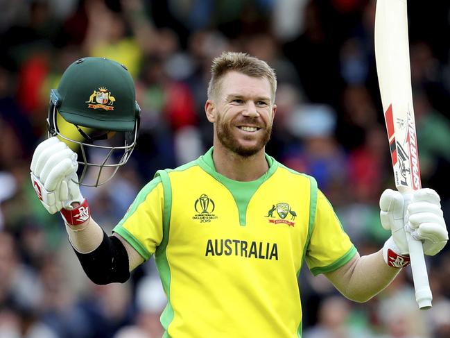 Australia's David Warner raises his bat and helmet to celebrate scoring a century during the Cricket World Cup match between Australia and Bangladesh at Trent Bridge in Nottingham, Thursday, June 20, 2019. (AP Photo/Rui Vieira)