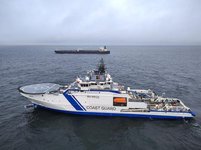 This handout picture released by The Finnish Border Guard on December 26, 2024 shows a Finnish Border Guard's ship Turva (front) and the oil tanker Eagle S on the sea near Porkkalanniemi. Finnish authorities said on December 26, 2024 that they were investigating an oil tanker that sailed from a Russian port for the "sabotage" of a power cable linking Finland and Estonia that was damaged the previous day. (Photo by Handout / Finnish Border Guard / AFP) / RESTRICTED TO EDITORIAL USE - MANDATORY CREDIT "AFP PHOTO /Finnish Border Guard" - NO MARKETING - NO ADVERTISING CAMPAIGNS - DISTRIBUTED AS A SERVICE TO CLIENTS