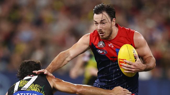 MELBOURNE. 24/04/2023. AFL. Round 6. Melbourne vs Richmond at the MCG.  Michael Hibberd of the Demons tries to fend off Richmonds Daniel Rioli  . Pic: Michael Klein