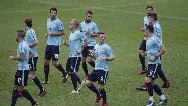 Australian soccer players jog during a training session at the Olympic Stadium in San Pedro Sula.