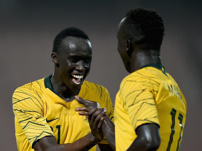 KUWAIT CITY, KUWAIT - OCTOBER 15:  Awer Mabil (R) of Australia celebrates with Thomas Deng (L) scoring his sides fourth goal during the International Friendly match between Kuwait and Australia at Al Kuwait Sports Club Stadium on October 15, 2018 in Kuwait City, Kuwait.  (Photo by Tom Dulat/Getty Images)