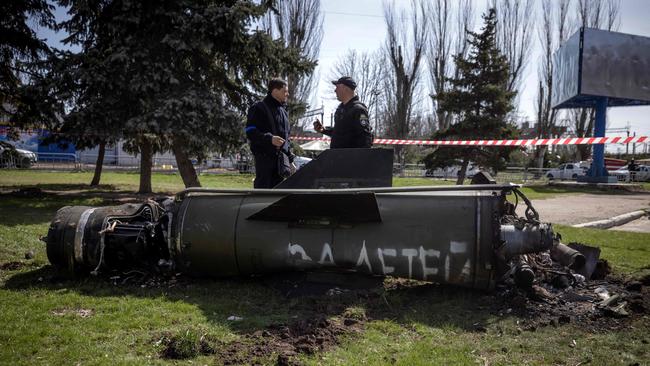 Ukrainian police inspect the remains of the Tochka-U rocket with the words ‘for our children’ in Russian at the train station in Kramatorsk. Picture: AFP