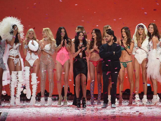 Candice Swanepoel, Adriana Lima, Behati Prinsloo, Romee Strijd, Alessandra Ambrosio, Kate Grigorieva, (Front Row L-R) singer Selena Gomez, Lily Aldridge and singer The Weeknd at the 2015 Victoria's Secret Fashion Show. Picture: Dimitrios Kambouris/Getty Images for Victoria's Secret