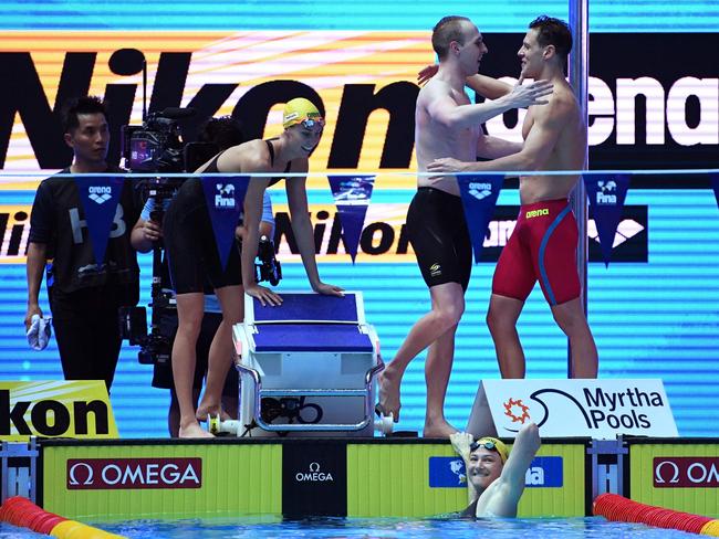 US Ryan Murphy (R) congratulates the Australian team Australia's Mitchell Larkin, Australia's Matthew Wilson, Australia's Emma McKeon and Australia's Cate Campbell on winning the final of the mixed 4x100m medley relay. Picture: Manan Vatsyayana/AFP