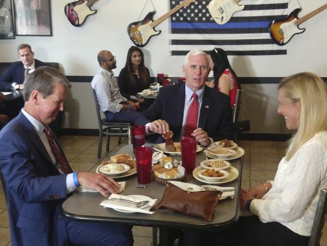 US Vice President Mike Pence eats lunch with Georgia Gov. Brian Kemp and his wife Marty Kemp at the Star Cafe. Mr Pence said Georgia was "leading the way" and the country was making progress against the coronavirus. Picture: The Washington Examiner via AP