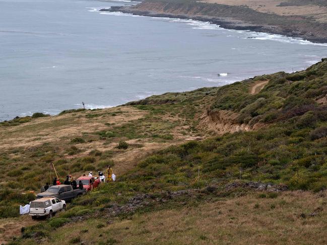 Rescue workers, forensics, and prosecutors work at a well where human remains were found near La Bocana Beach, Santo Tomas delegation, in Ensenada, Baja California State, Mexico. Picture: AFP