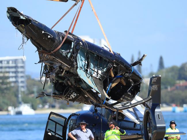 Queensland Police and ATSB Officers recover the wreckage of the choppe in which four people were killed. Picture: Scott Powick