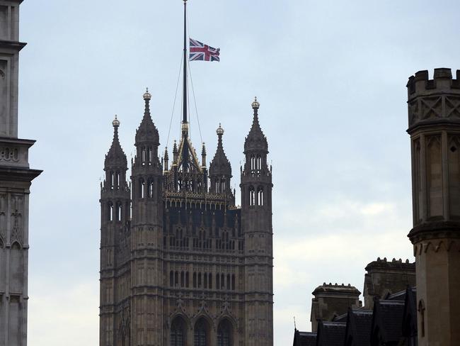 The flag above the Houses of Parliament flies at half mast, the day after the London terrorist attack. Picture: AP