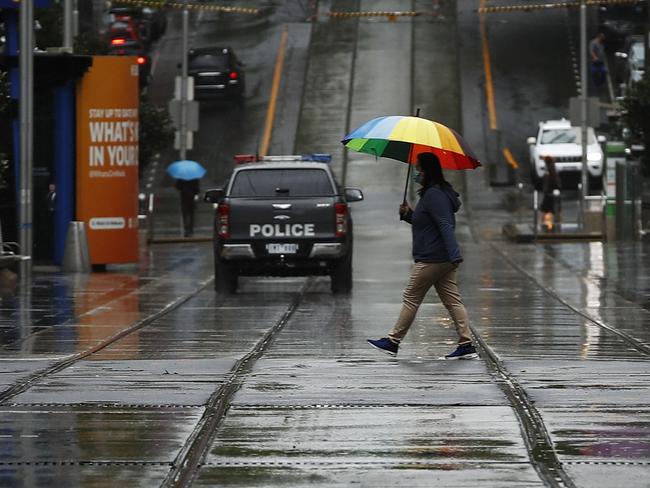 MELBOURNE, AUSTRALIA - NCA NewsWire Photos October 24, 2020:   A person walks across a quiet Bourke Street Mall in the rain in Melbourne, Victoria. Picture: NCA NewsWire / Daniel Pockett