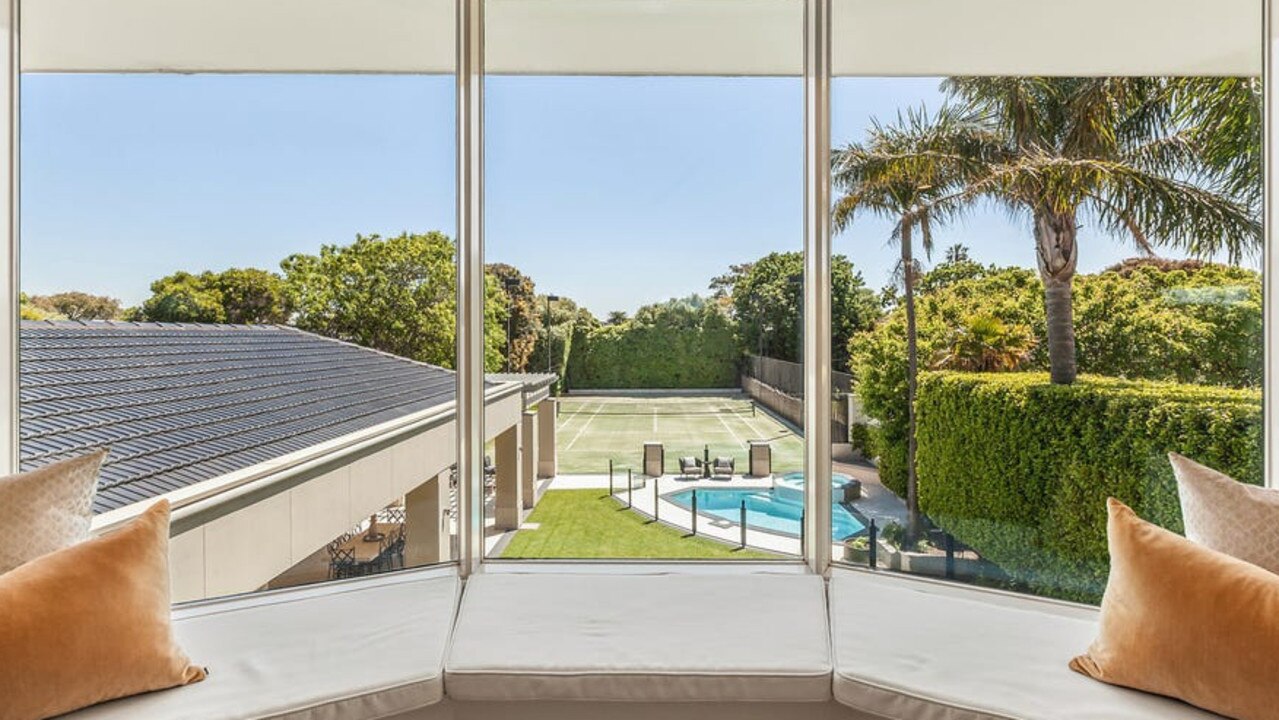 Views of the tennis court and back yard from the main bedroom upstairs.