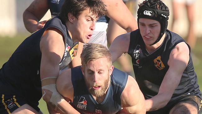 Scotch Old Collegians’ Cooper De Zylva (left) and Hugo Walter (right) put Henley’s Sean Baker under the pump during the Lions’ win in round 12 – the first of a run of three straight. Picture: Dean Martin