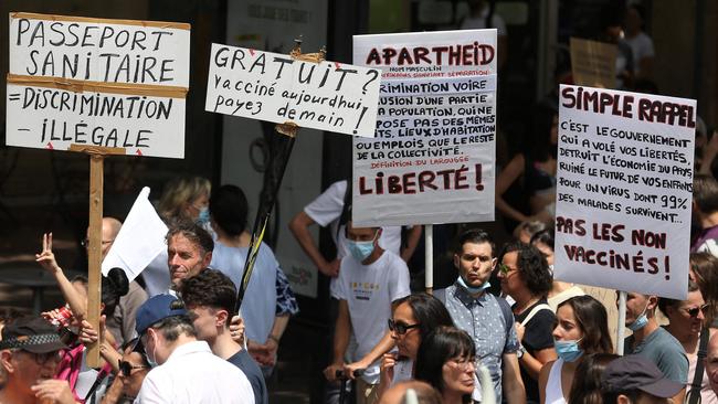 Demonstrators hold up placards and banners with slogans such as health Passport = illegal Discrimination, during a protest in southwestern France. Picture: AFP