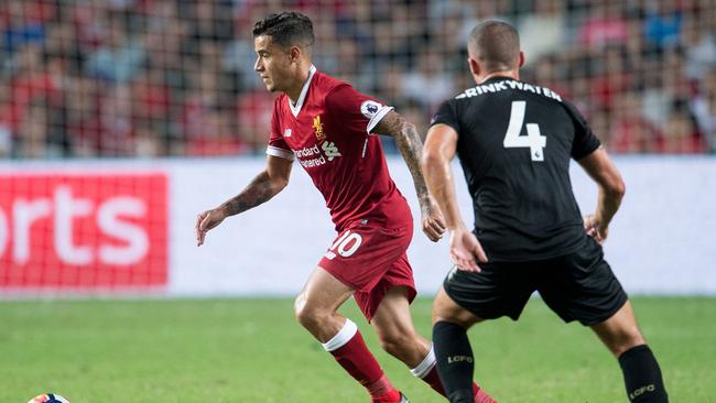 Liverpool's Philippe Coutinho (L) controls the ball