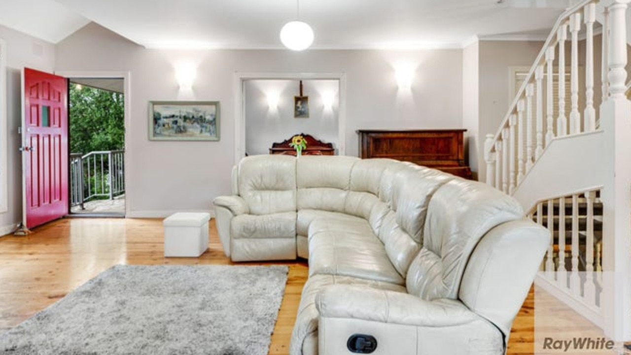 The ground floor living space, with stairs to the first and lower ground floors.