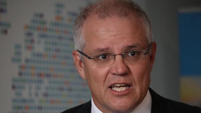 Treasurer Scott Morrison says Mr Abbott's call to drastically cut Australia's migration intake would cost the federal budget up to $5 billion. Source: AAP Image/Alex Murray.