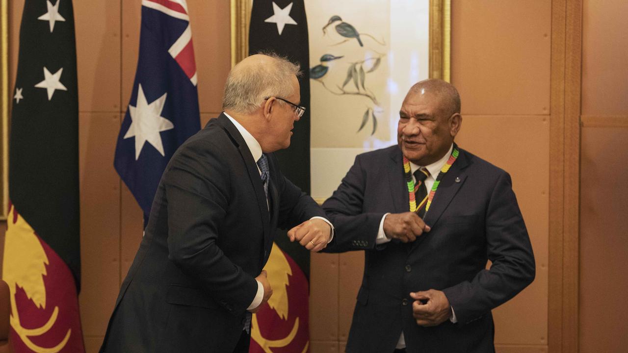 Prime Minister Scott Morrison shoulder bumps PNG's High Commissioner John Kali. PNG is in a tug of war between China and Australia. Picture: NCA NewsWire/Gary Ramage