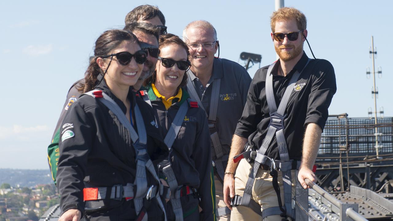Prince Harry on top of the Sydney Harbour Bridge with members of Australia’s team for the Invictus Games, Gwen Cherne and Prime Minister Scott Morrison. Picture: Getty Images