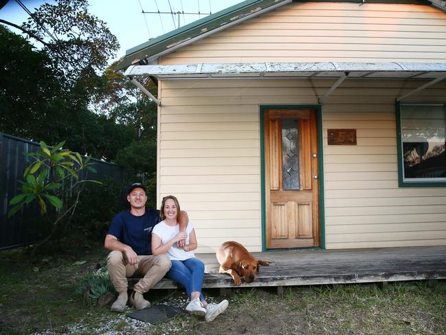 First home buyers Builder Braden Hodder, 25, and his girlfriend pre school teacher Hannah Wildey, 24, pictured Friday 3rd August 2018 at the house they have just bought  at Ettalong Beach with dog Billy. Pic Sue Graham