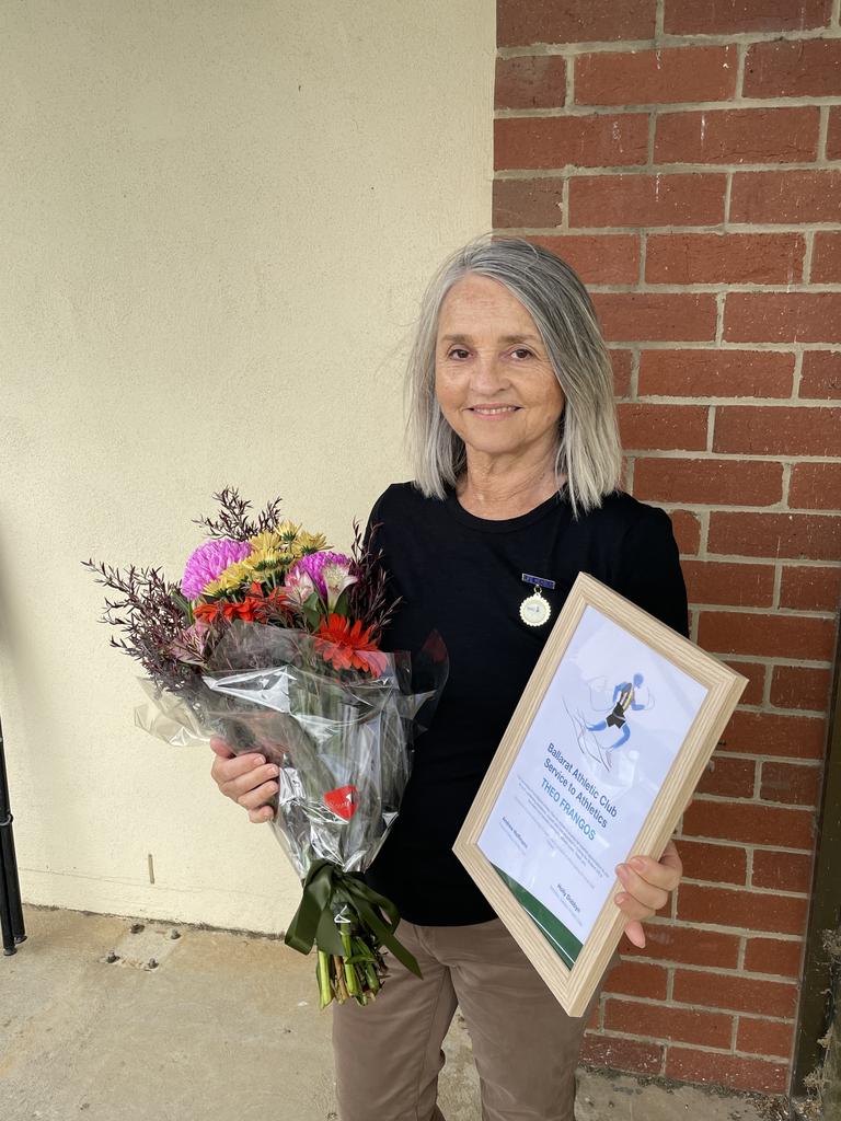 Judy Frangos with flowers and a certificate her late husband received. Theo Frangos was posthumously awarded a service to Ballarat Athletics during the Gift. Picture: Shane Jones.