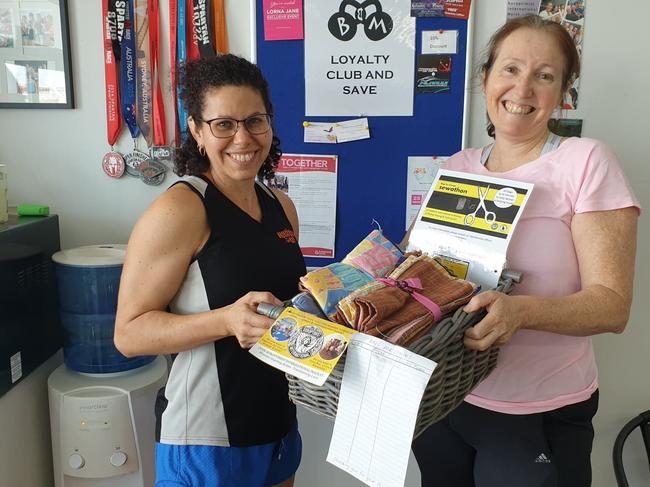 Soroptimist International Mackay members Maria Surian and Leanne Simpson holding fabric to be transformed into bags for families to get groceries at the St Vincent de Paul Society. Picture: Contributed