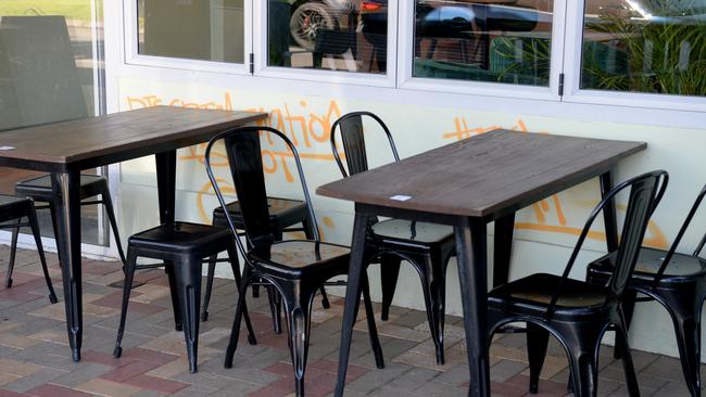 Anti-vax graffiti on the Blacksheep cafe in South Kingsville obscured by table. Picture: NCA NewsWire / Andrew Henshaw